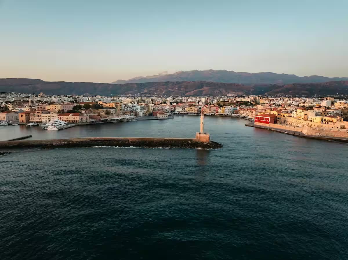 Aerial view of the historic Egyptian-Venetian Lighthouse and Old Harbor of Chania, Crete, Greece at sunset