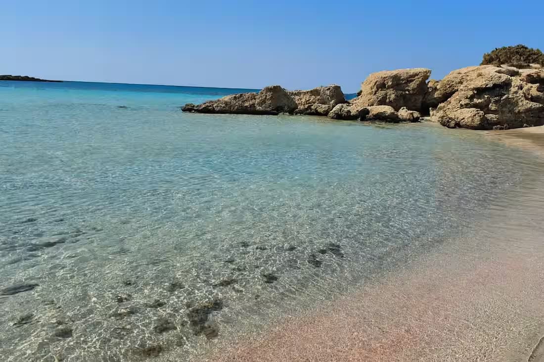 Incredibly clear, shallow turquoise waters of the Elafonisi Lagoon, Southwest Crete, famous for its unique pink sand beach