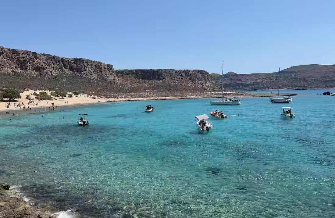 Elevated view of Balos Lagoon and Imeri Gramvousa island, Chania, Northwest Crete, featuring turquoise and deep blue water and a pristine sandy beach