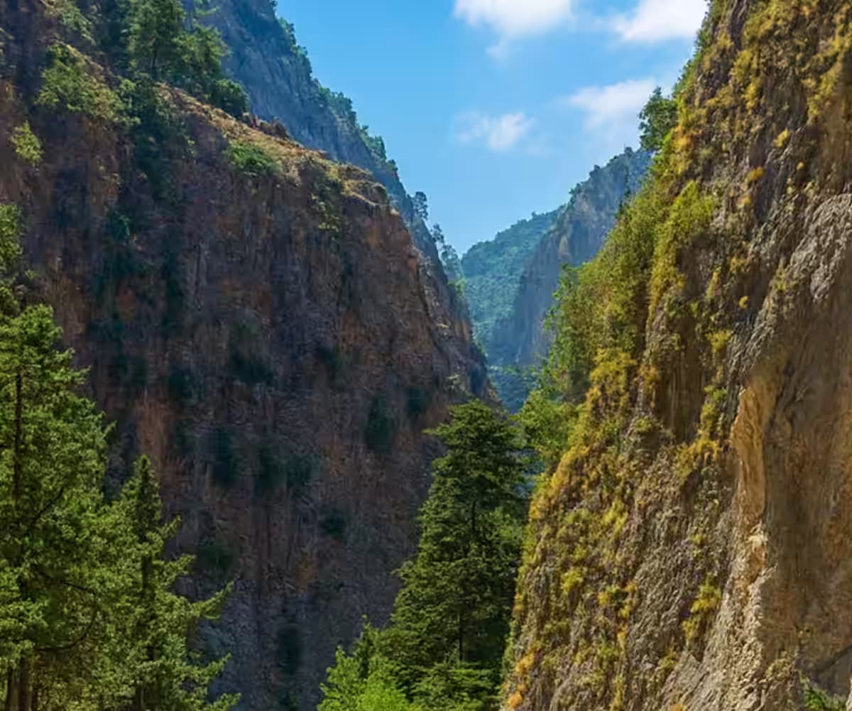 Narrow passage and towering cliffs inside the rugged Samaria Gorge National Park, Southwest Crete, Greece