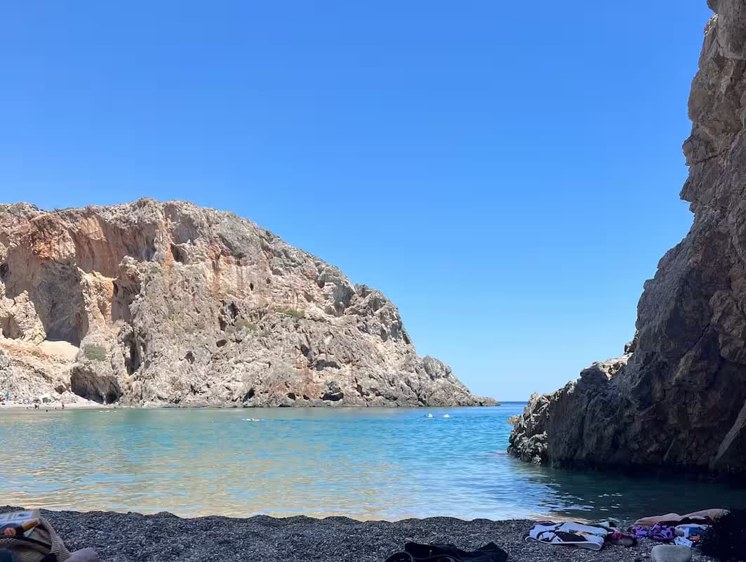 Secluded Agiofarago Beach (Gorge of the Saints) with clear turquoise water and high rocky cliffs, South Crete, Greece